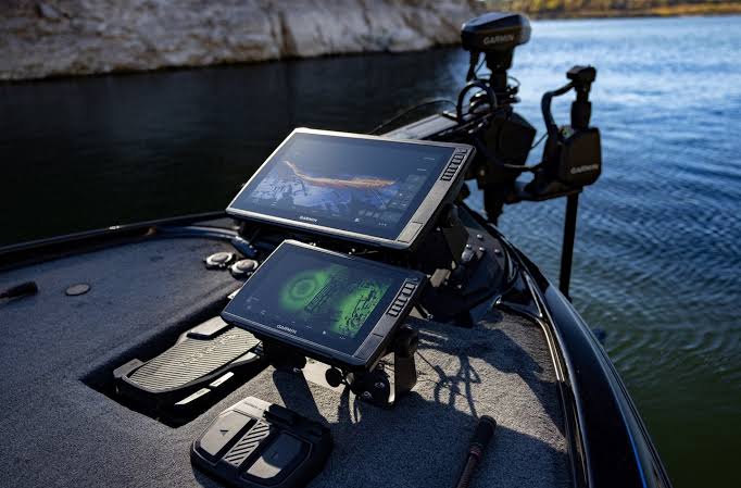 Dual Garmin LiveScope displays professionally rigged on a bass boat bow with Minn Kota trolling motor and Power-Pole, out on the water